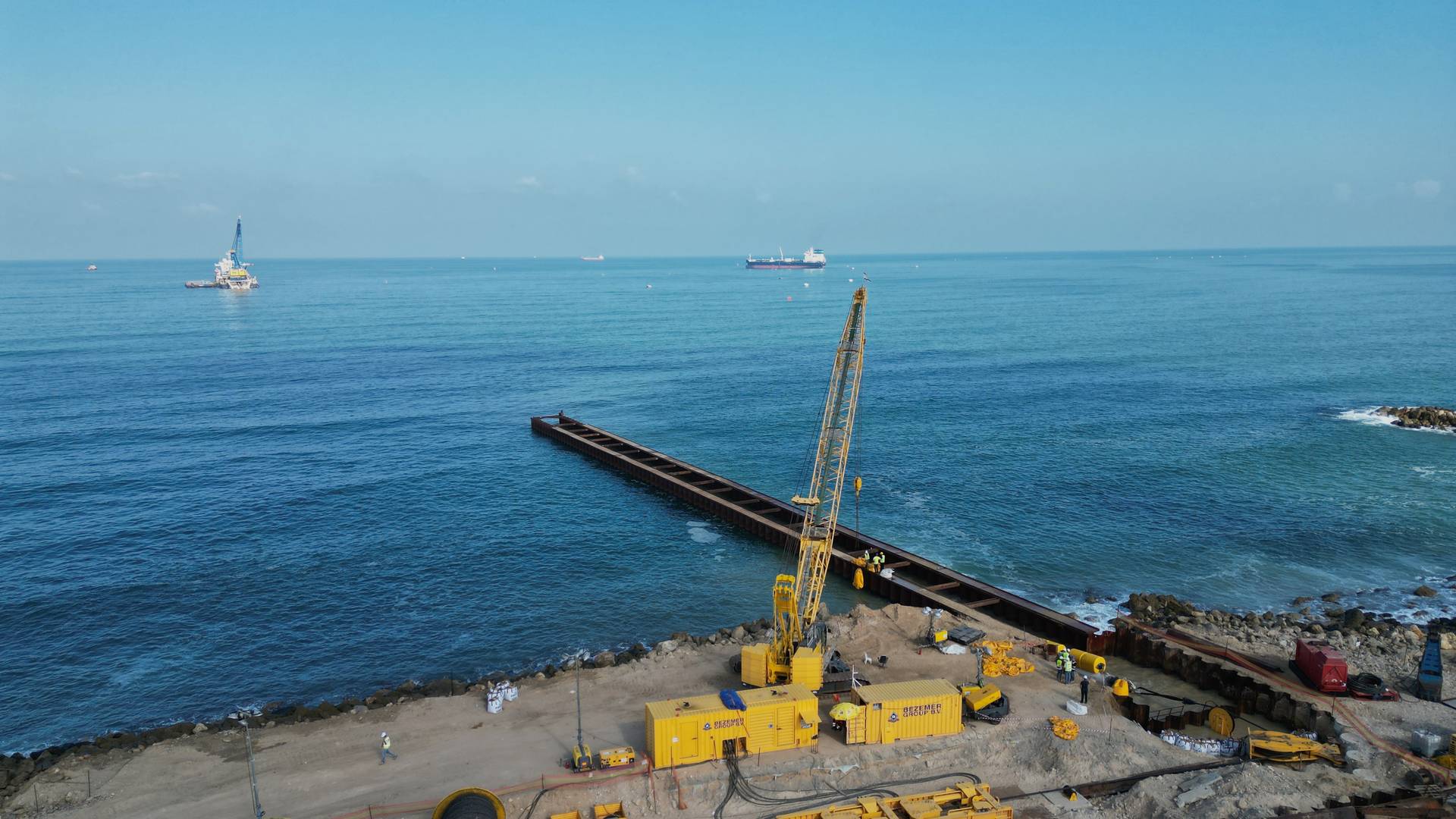 Cofferdam landfall construction at the Ashkelon site — crane and sheet-pile structure extending into the Mediterranean